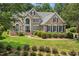 Traditional brick home with manicured landscaping, showcasing its curb appeal and inviting facade on a sunny day at 402 Bridewell Ct, Cary, NC 27518