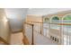 Second-floor hallway overlooking the foyer and featuring large arched windows at 402 Bridewell Ct, Cary, NC 27518