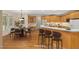 Eat-in kitchen boasts breakfast bar, wood cabinetry, stainless steel appliances and dining area at 402 Bridewell Ct, Cary, NC 27518