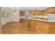Bright kitchen featuring wooden cabinets, breakfast bar and hardwood floors at 402 Bridewell Ct, Cary, NC 27518