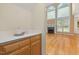 Living room view showcasing countertop area with a fireplace and soaring windows in background at 402 Bridewell Ct, Cary, NC 27518