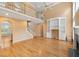 Spacious living room boasts hardwood floors, built-in shelving, and an open layout with a staircase at 402 Bridewell Ct, Cary, NC 27518