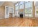 Bright living room with a fireplace, built-in shelving, and soaring windows at 402 Bridewell Ct, Cary, NC 27518