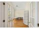 Bright office features a built-in desk, shelving, hardwood floors, and natural light from large windows at 402 Bridewell Ct, Cary, NC 27518