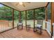 Comfortable screened porch with rocking chairs offers a serene view of the lush, green outdoors at 402 Bridewell Ct, Cary, NC 27518