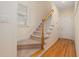 Inviting carpeted staircase with hardwood accents and natural light at 402 Bridewell Ct, Cary, NC 27518