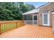 A sunny wooden deck with a freshly painted railing leads to a screened-in porch at 402 Bridewell Ct, Cary, NC 27518
