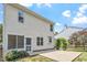 Two-story home backyard with a patio area, a well-maintained lawn, and beautiful landscaping around the perimeter at 404 Ascott Way, Durham, NC 27713