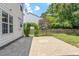 Relax on the brick-paved backyard patio, complete with an archway and a beautiful lush green lawn at 404 Ascott Way, Durham, NC 27713