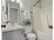 Full bathroom featuring white vanity, toilet, bathtub, and tile surround plus decorative plants at 404 Ascott Way, Durham, NC 27713