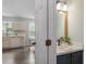 Bright bathroom featuring modern vanity with marble countertop and dark blue cabinets at 404 Ascott Way, Durham, NC 27713