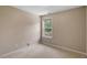Bedroom featuring carpet, neutral wall color, and a window with a backyard view at 404 Ascott Way, Durham, NC 27713