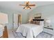 Bright bedroom features a white bed with sliding door access to the bathroom at 404 Ascott Way, Durham, NC 27713