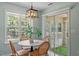 Eat-in kitchen area, showcasing backyard views and modern pendant lighting at 404 Ascott Way, Durham, NC 27713