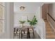Dining room featuring a modern table, stylish decor, decorative accents, view of stairs and accent wall trim at 404 Ascott Way, Durham, NC 27713