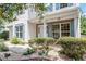 Inviting front porch with brick accents, stylish columns, manicured bushes and attractive landscaping at 404 Ascott Way, Durham, NC 27713
