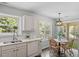 Bright eat-in kitchen with stainless dishwasher and sliding doors to the backyard at 404 Ascott Way, Durham, NC 27713