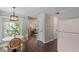Open-concept dining area leading into the living room with hardwood floors at 404 Ascott Way, Durham, NC 27713