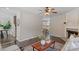 Inviting living room featuring a fireplace, neutral colored furniture, ceiling fan, wood floors and decorative rug at 404 Ascott Way, Durham, NC 27713