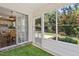 Sunroom offering a view of the outdoor patio and garden, with sliding glass doors to the interior kitchen at 404 Ascott Way, Durham, NC 27713