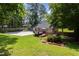 Large backyard featuring a deck, hot tub, patio, and ample green space perfect for outdoor activities at 404 Sw Maynard Rd, Cary, NC 27511