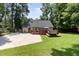 Backyard view showcases a spacious patio, deck with hot tub, and green lawn, ideal for outdoor living at 404 Sw Maynard Rd, Cary, NC 27511