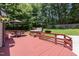 Backyard deck with outdoor seating, patio umbrella, and a hot tub, perfect for relaxation and entertainment at 404 Sw Maynard Rd, Cary, NC 27511