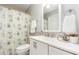 Well-maintained bathroom with modern vanity, decorative shower curtain, and tiled backsplash for a fresh look at 404 Sw Maynard Rd, Cary, NC 27511