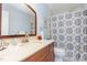 Classic bathroom with a vanity, framed mirror, and shower, blending functionality with a touch of style at 404 Sw Maynard Rd, Cary, NC 27511