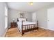 Cozy bedroom with hardwood floors, neutral walls, and a comfortable bed with a decorative pillow at 404 Sw Maynard Rd, Cary, NC 27511