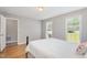 Bright bedroom features two windows, neutral walls, and wood floors, offering a cozy and inviting atmosphere at 404 Sw Maynard Rd, Cary, NC 27511