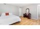 Comfortable bedroom with wood floors and vanity mirror provides a relaxing and functional living space at 404 Sw Maynard Rd, Cary, NC 27511
