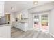 Kitchen with white cabinets, stainless steel appliances, granite countertops, and a view to the outdoor deck at 404 Sw Maynard Rd, Cary, NC 27511