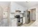 Modern kitchen features stainless steel appliances, granite countertops, and white cabinetry at 404 Sw Maynard Rd, Cary, NC 27511