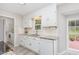 Bright kitchen with white cabinets, stainless steel appliances, granite countertops, and natural light at 404 Sw Maynard Rd, Cary, NC 27511