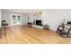 Inviting living room featuring a cozy fireplace, hardwood floors and french doors at 404 Sw Maynard Rd, Cary, NC 27511