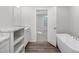 Bright bathroom featuring a soaking tub, marble countertops, and white cabinets at 41 Andrea Ct, Sanford, NC 27332