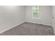 Bright bedroom featuring gray carpet and a window allowing for ample natural light at 41 Andrea Ct, Sanford, NC 27332