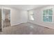 Bright bedroom with neutral carpet and paint, with a hallway leading to other rooms at 41 Andrea Ct, Sanford, NC 27332
