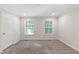 Bright bedroom featuring neutral paint, carpet, and two windows for natural light at 41 Andrea Ct, Sanford, NC 27332