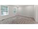 Neutral bedroom with two large windows providing natural light and plush, cozy carpeting at 41 Andrea Ct, Sanford, NC 27332