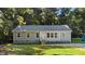 Charming single-story home with light green siding, gray roof, and inviting front entrance surrounded by lush trees at 41 Andrea Ct, Sanford, NC 27332