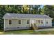 Inviting single-story home with light green siding, gray roof, and wood-finished stairs leading to the front entrance at 41 Andrea Ct, Sanford, NC 27332