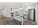 Modern kitchen with white cabinets, stainless appliances, an island, and durable laminate flooring for style and function at 41 Andrea Ct, Sanford, NC 27332