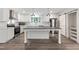 Beautiful kitchen features white cabinetry, stainless steel appliances, and a gray countertop island with pendant lighting at 41 Andrea Ct, Sanford, NC 27332