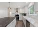 Modern kitchen with white cabinetry, gray countertop island, stainless-steel appliances, and stylish laminate flooring at 41 Andrea Ct, Sanford, NC 27332
