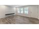 Bright living room with large windows, light-colored flooring, a wall with decorative paneling, and a floating shelf at 41 Andrea Ct, Sanford, NC 27332