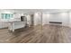Spacious living room and kitchen with recessed lights, stylish gray floors, white cabinets, and sliding barn door at 41 Andrea Ct, Sanford, NC 27332