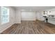 Open-concept living space with new light-colored floors, leading into the kitchen, brightened by natural light at 41 Andrea Ct, Sanford, NC 27332