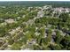 A lush aerial view showcases the neighborhood's mature trees, serene streets, and a glimpse of a community pool at 412 Coggeshall St, Oxford, NC 27565
